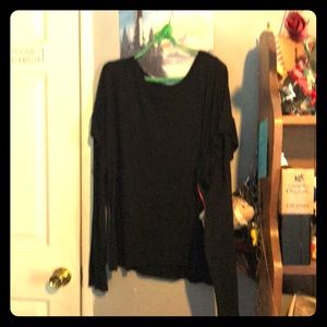 Long sleeve black shirt ruffles on the shoulder.
